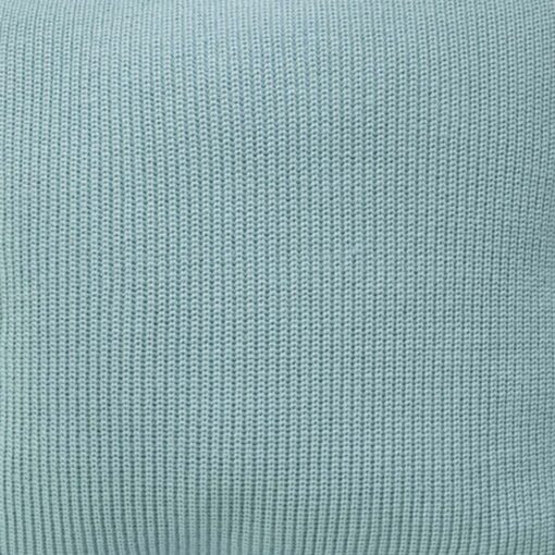 Close up photo of knitted cushion cover of teal colour