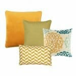 An image of a gold cushion, a yellow cushion, a paisley inspired design cushion and a yellow and white rectangular cushion.