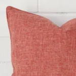 A zoomed view of this linen auburn cushion’s corner that has a square design.