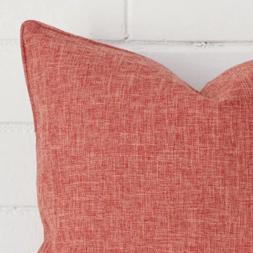A zoomed view of this linen auburn cushion’s corner that has a square design.