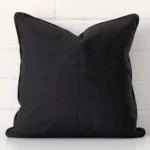 Vibrant black cushion cover constructed from linen fabric and shown in a square size.