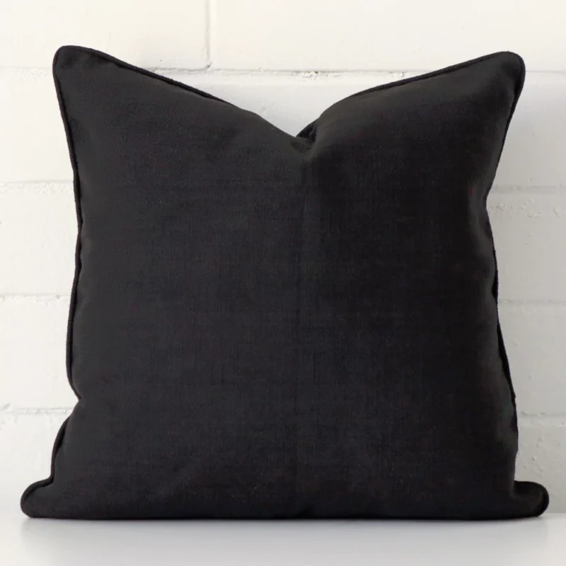 Vibrant black cushion cover constructed from linen fabric and shown in a square size.