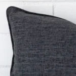 Extreme close up of a rectangle charcoal cushion. The linen fabric is shown with a much higher degree of detail.