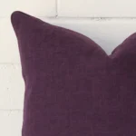 A linen plum cushion cover shown laying on its side. The square size is shown side on.
