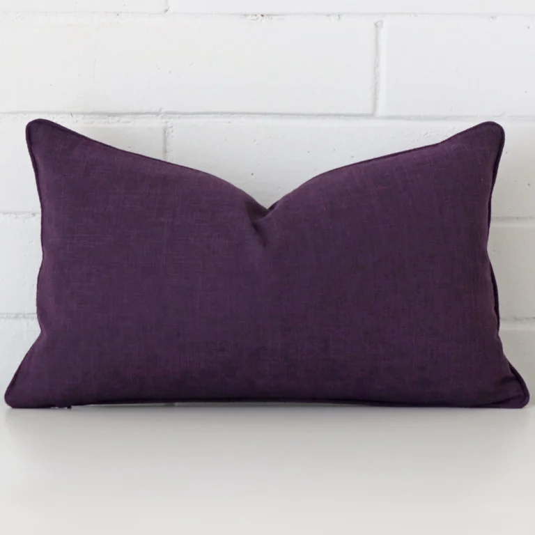 Vibrant plum cushion cover constructed from linen fabric and shown in a rectangle size.