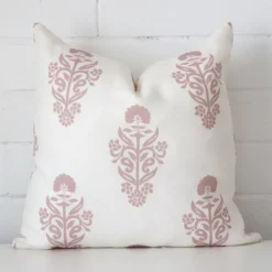 A stunning square linen cushion in a pink colour. It has an exquisite patterned design.