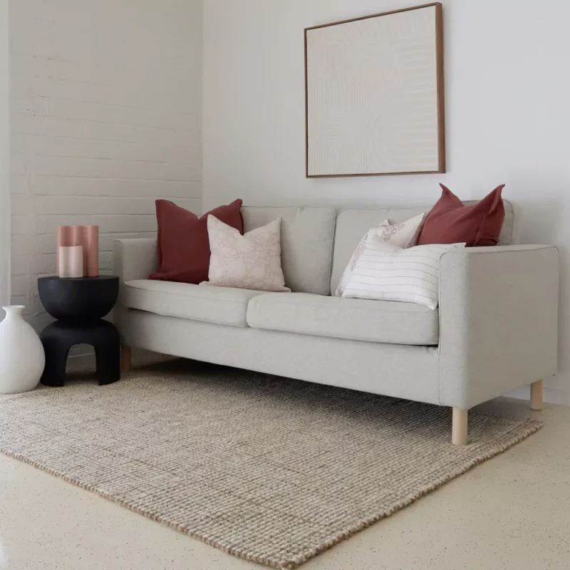 The set of 5 Ali sofa cushions stand out in a living room.