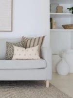 3 cushions Cushions from the set of 5 designer cushions for the Amaro set are arranged in the corner of an elegant grey sofa.
