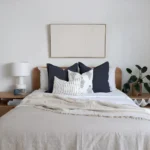 The bedroom gets a cozy touch with a set of four blue-hued cushions from the Amelie bed cushion set.