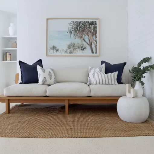 The set of 5 Amelie sofa cushions in a bright and white living room.