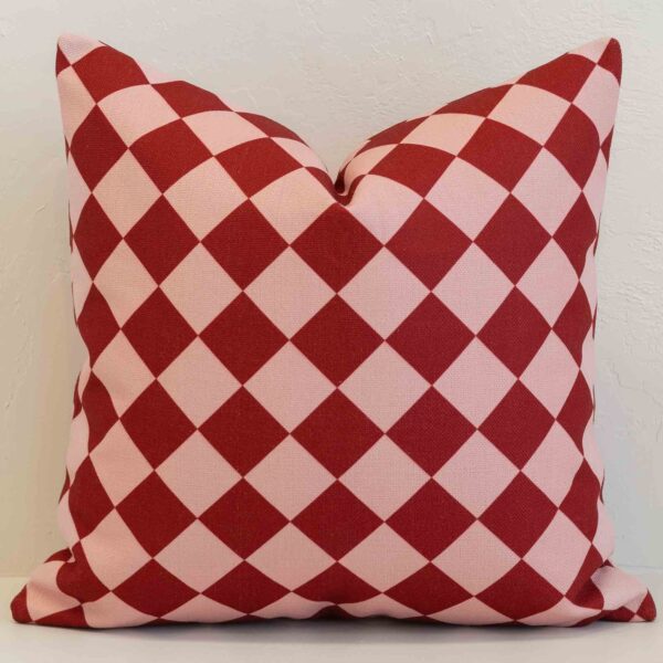 Amora diamond gingham cushion with red and pale pink check pattern.