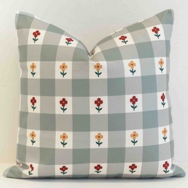 Amora gingham check cushion with small flowers on soft green grid pattern.