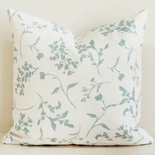 Cream cushion cover with soft sage green leaf branch print.
