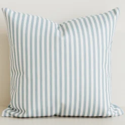 Sage pinstripe cushion cover on cream cotton-linen base.