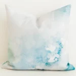Seafoam green watercolour print cushion cover on cream fabric.