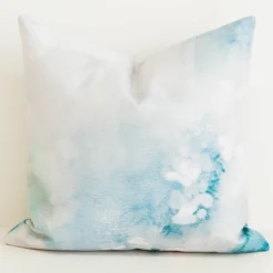 Seafoam green watercolour print cushion cover on cream fabric.