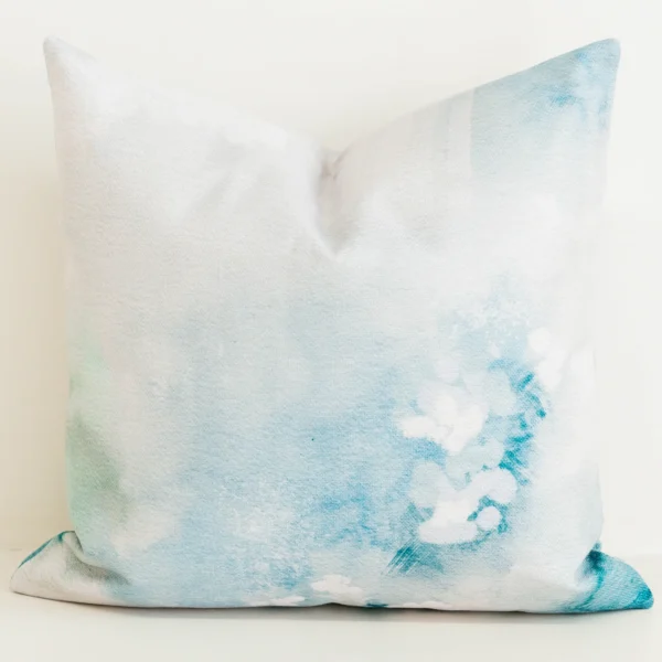 Seafoam green watercolour print cushion cover on cream fabric.