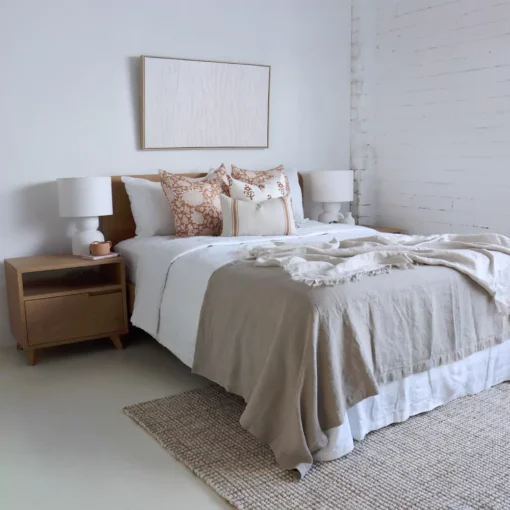 A white bedroom with wooden furnitures and the set of 4 Aria bed cushions.