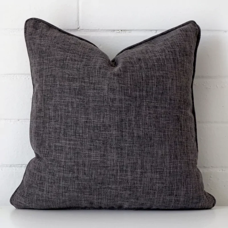arlington-grey-brown-cushion-cover-45cm-x-45cm-sc457-45 Grey cushion leans elegantly against a brick wall. It has been crafted from a high quality linen material and has a square shape.