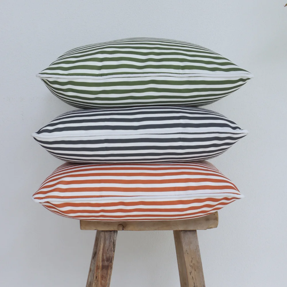 An arranged tower of striped outdoor cushions.