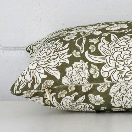 Horizontal edge view of front and back panels of a floral linen cushion in a SIZE size and with olive green colouring.