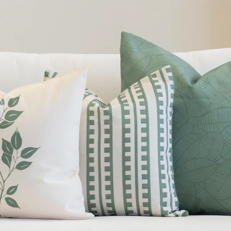 A white couch is styled with a set of 3 avena outdoor cushions.