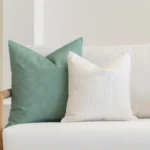 A set of avena outdoor cushions tucked in the corner of a white sofa.