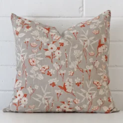 A graceful square grey cushion with a floral style on durable linen fabric.