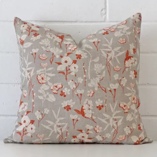 A graceful square grey cushion with a floral style on durable linen fabric.