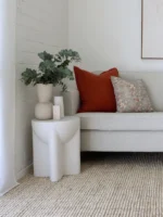 A corner of a light grey sofa with 2 cushions from the set of 5 Avery sofa cushions.