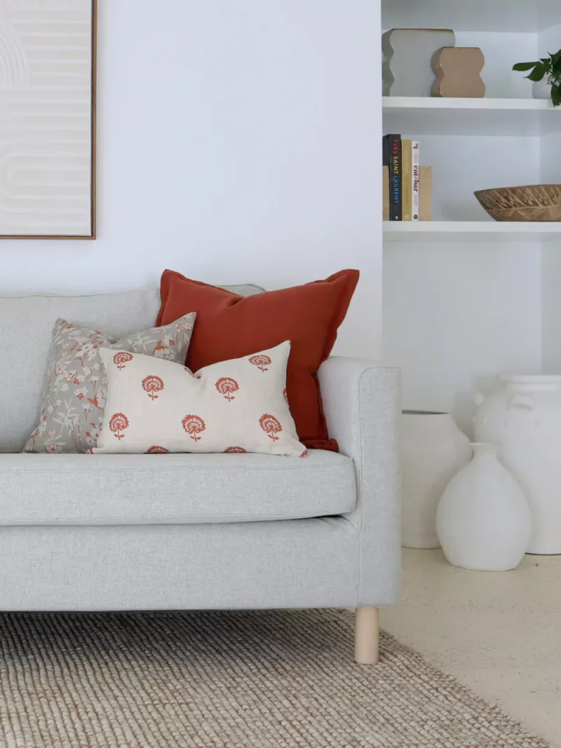 Cushions from the Avery sofa cushions set of 5 add warmth to a white living room.