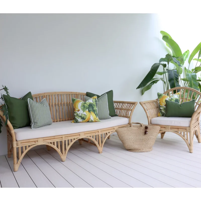 banana-olive-outdoor-lounge-cushions-set-7-covers-colo1178 Outdoor sofa adorned with seven olive cushions snugly surrounded by lush greenery.