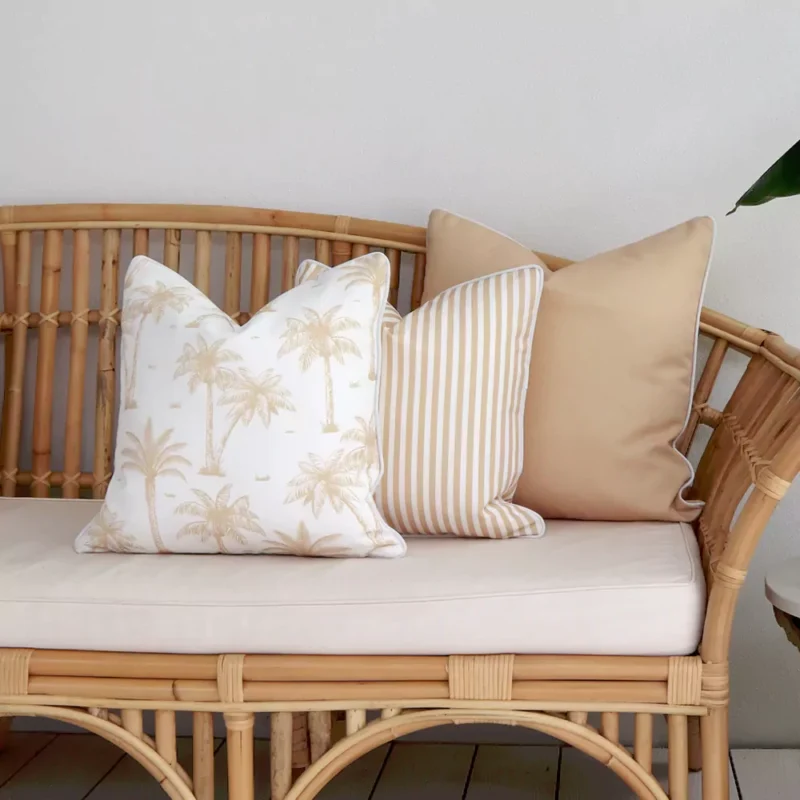 beige-outdoor-couch-cushions-set-3-covers-colo1163c Three beige outdoor couch cushions arranged at the end of a rattan seat.