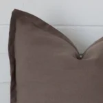 A zoomed view of this linen brown cushion’s corner that shows a magnified view of its large size.
