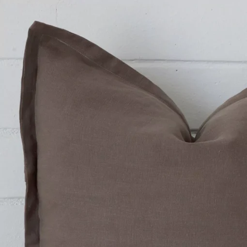 A zoomed view of this linen brown cushion’s corner that shows a magnified view of its large size.