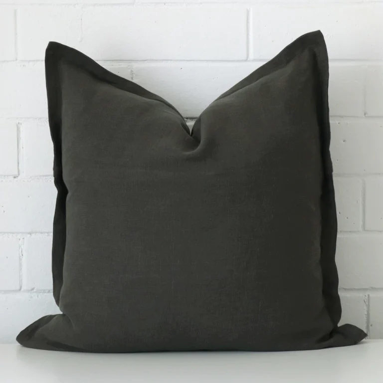 A graceful large moss green cushion that is made from a linen fabric.
