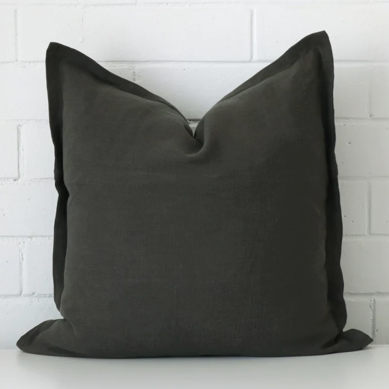 A graceful large moss green cushion that is made from a linen fabric.