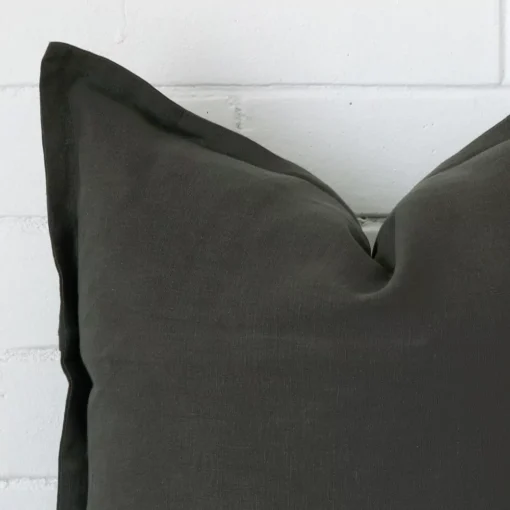 This image shows a moss green cushion cover from a very close range. The large size and linen material are more clearly shown.