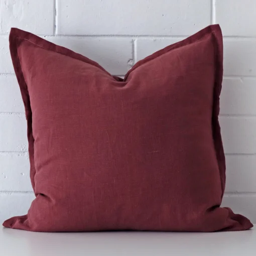Vibrant plum cushion cover constructed from linen fabric and shown in a large size.