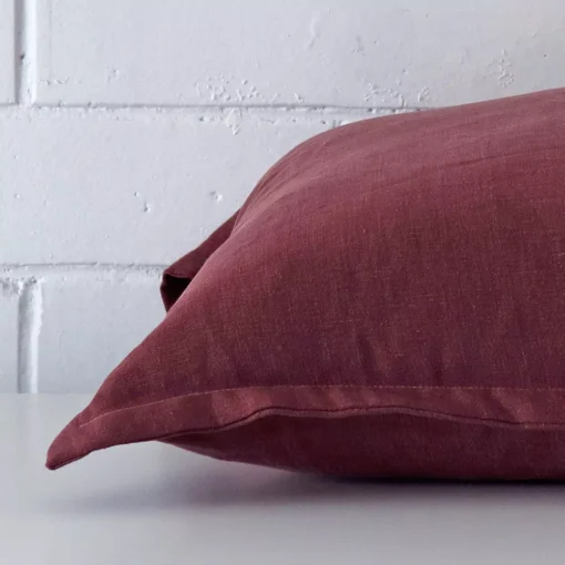 Side image of a linen largecushion cover. The plum colour is visible from the side showing the attachment of the panels.