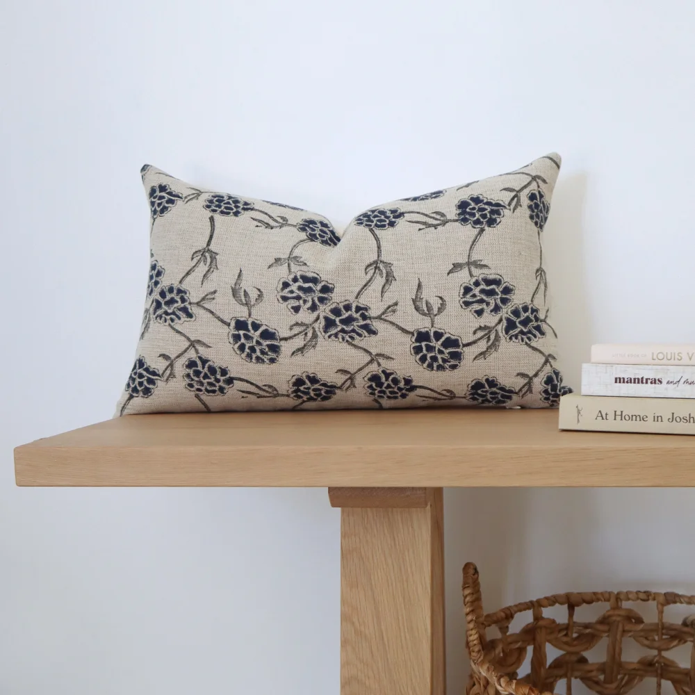 A bench seat with a styled rectangle cushion on its top.