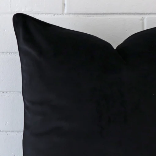 This image shows a black cushion cover from a very close range. The large size and velvet material are more clearly shown.