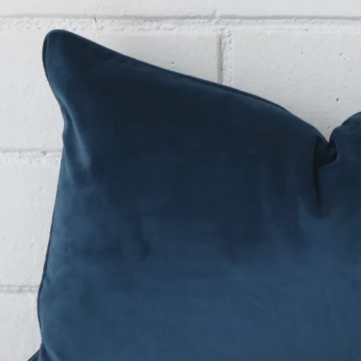 This image shows a blue cushion cover from a very close range. The rectangle size and velvet material are more clearly shown.