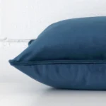 A blue cushion positioned on its back panel. The shot shows a lateral view of the velvet fabric and its rectangle size.