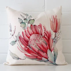 A bold floral linen cushion in a sleek square size.