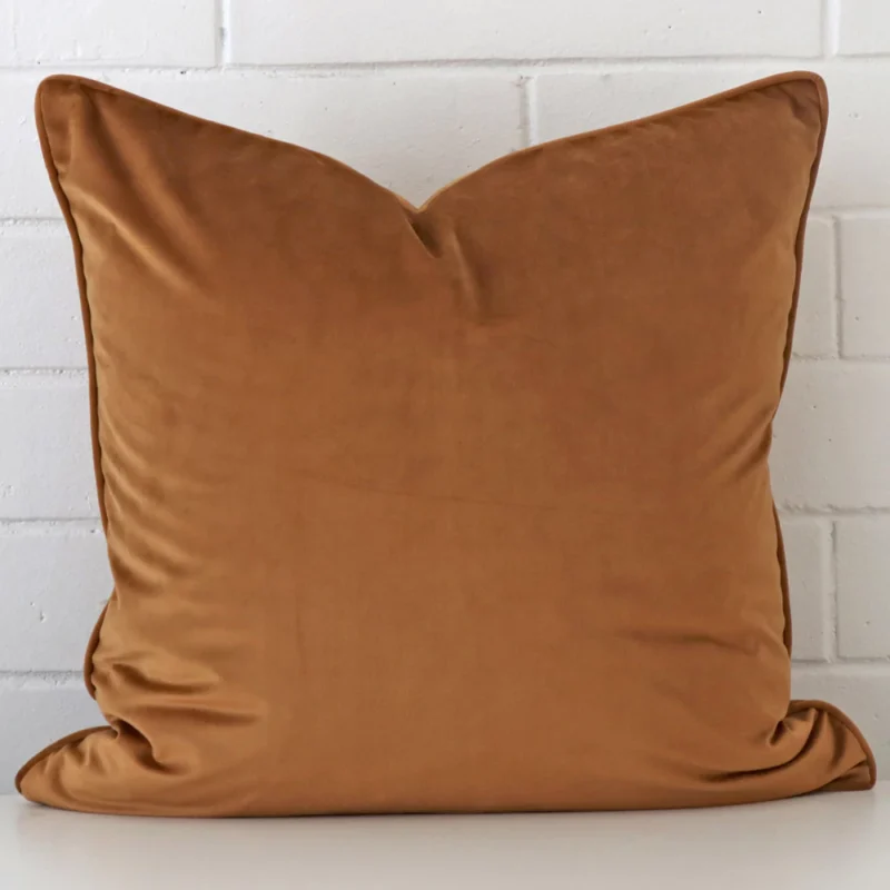 bronze-velvet-cushion-cover-large-sc1036-55 A velvet large cushion cover that is shown vertically against a brick wall. It has a wonderful bronze colour.