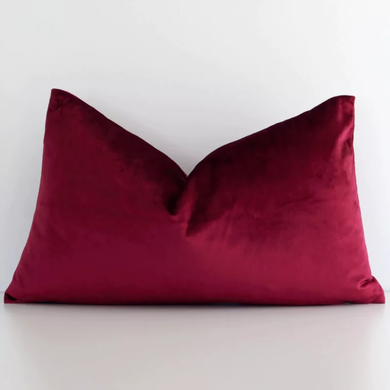 burgundy-velvet-rectangular-cushion-cover---rectangle---sc781-30 Burgundy solid colour cushion leans elegantly against a white wall. It has been crafted from a high quality velvet material and has a rectangle shape.