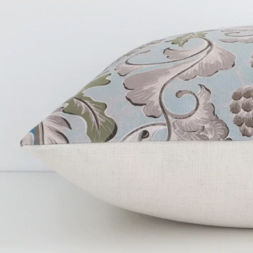 The edge of this linen square cushion with a colorful finish is shown. The shot highlights the patterned design, as well as the front and rear panels.