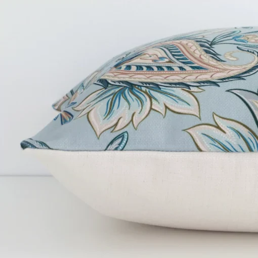 A side view of colourful patterned cushion that has linen fabric and a square size.