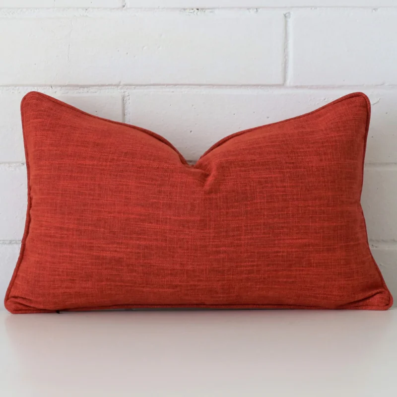 camden-burnt-orange-cushion-cover-30cm-x-50cm-sc452-30 Here a burnt orange linen cushion is shown styled against a white wall. It has a rectangle design.